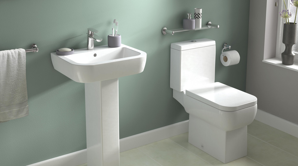 Modern inredning av ett litet badrum, med ett väggmonterat handfat, en toalettstol med hel cisternkåpa, grå väggar och linoleumgolv