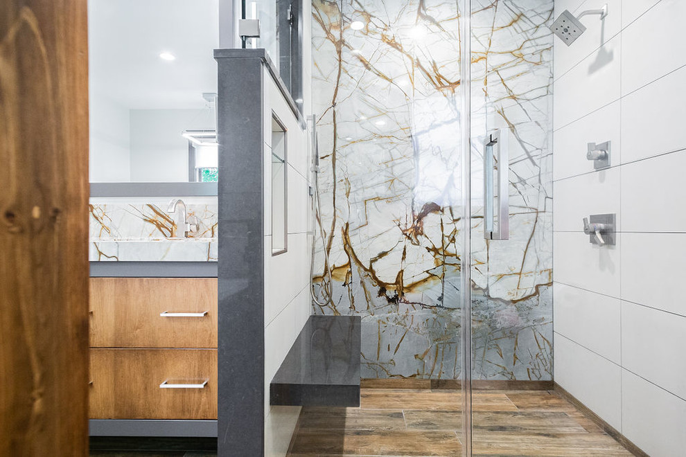 Mid-sized minimalist porcelain tile porcelain tile and brown floor bathroom photo in Other with flat-panel cabinets, gray cabinets, a two-piece toilet, white walls, an undermount sink, quartzite countertops and a hinged shower door