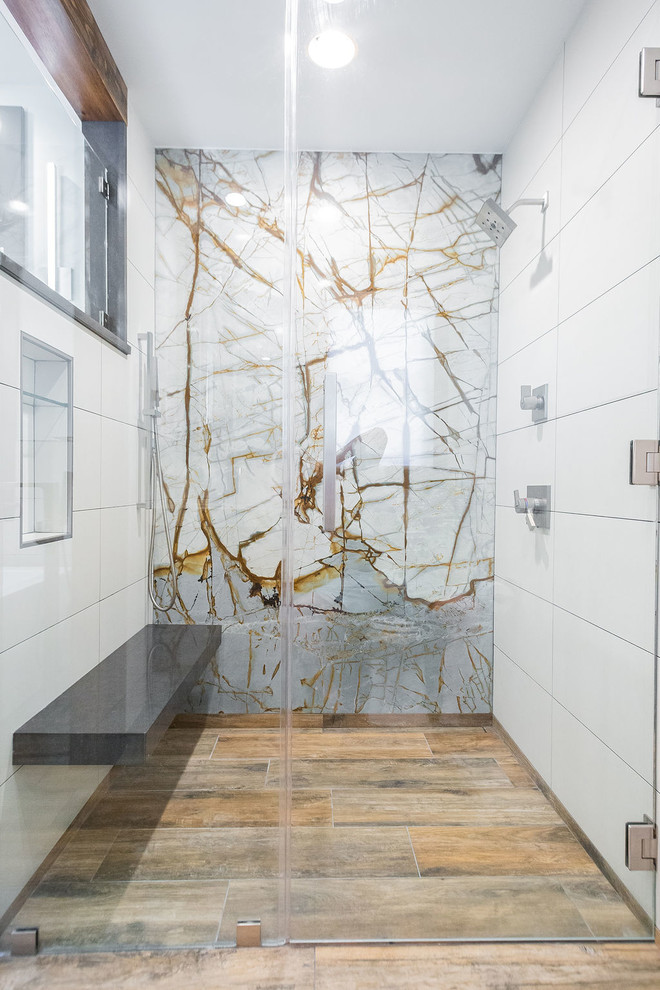 Example of a mid-sized minimalist porcelain tile porcelain tile and brown floor bathroom design in Other with flat-panel cabinets, gray cabinets, a two-piece toilet, white walls, an undermount sink, quartzite countertops and a hinged shower door