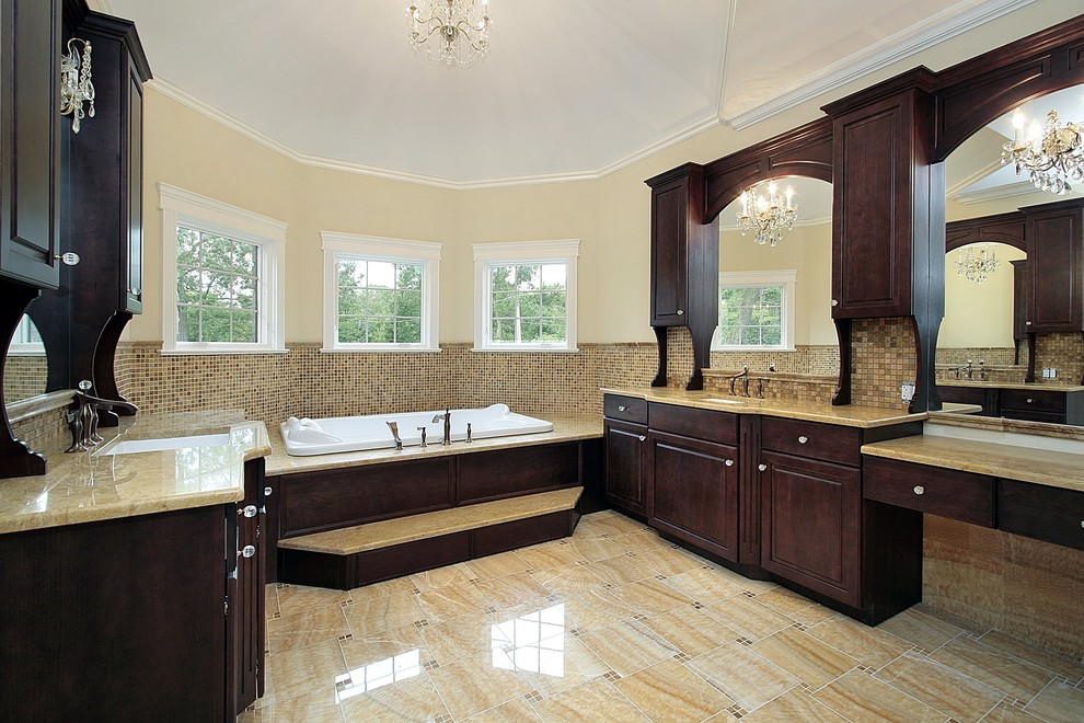 Ispirazione per una stanza da bagno moderna con ante in legno bruno, vasca da incasso, consolle stile comò, top in granito, piastrelle beige e piastrelle a mosaico