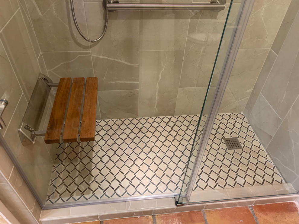 Photo of a medium sized classic ensuite bathroom in Austin with raised-panel cabinets, dark wood cabinets, an alcove shower, a two-piece toilet, brown tiles, porcelain tiles, yellow walls, terracotta flooring, a submerged sink, granite worktops, orange floors, a sliding door, beige worktops, a shower bench, double sinks and a built in vanity unit.