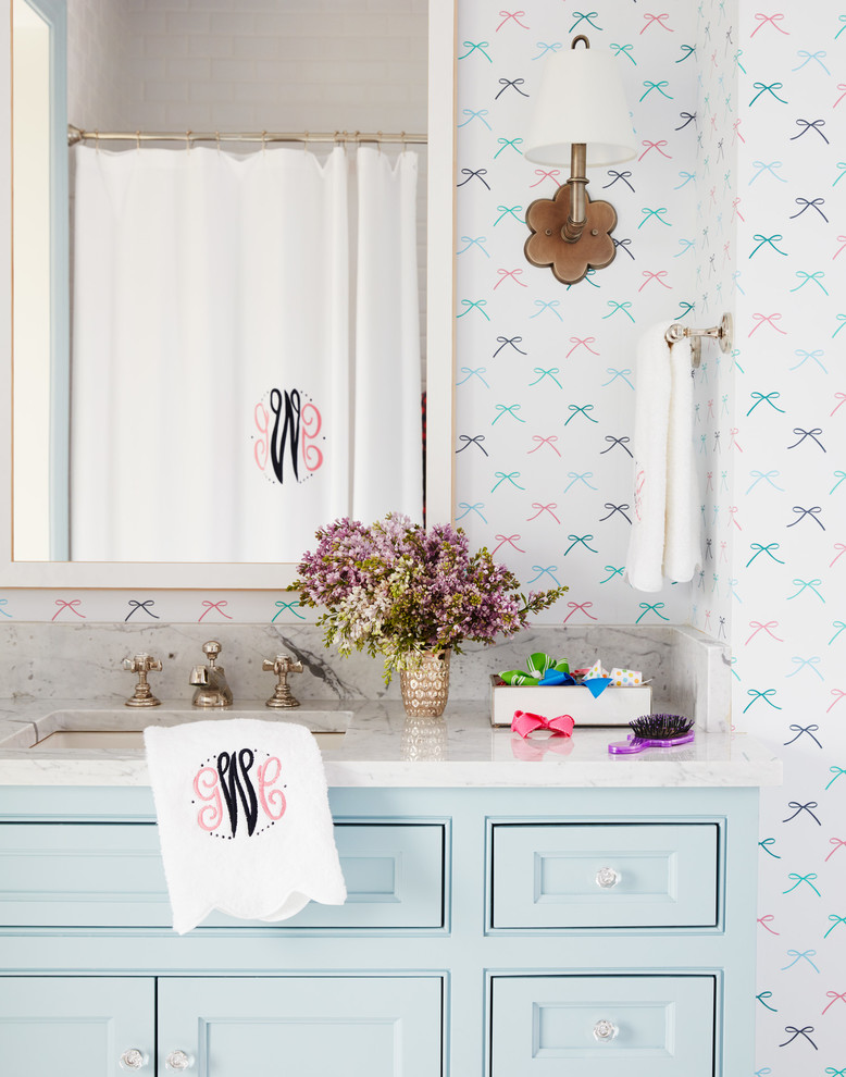 Example of a mid-sized beach style kids' bathroom design in Jacksonville with flat-panel cabinets, blue cabinets, multicolored walls, an undermount sink and soapstone countertops