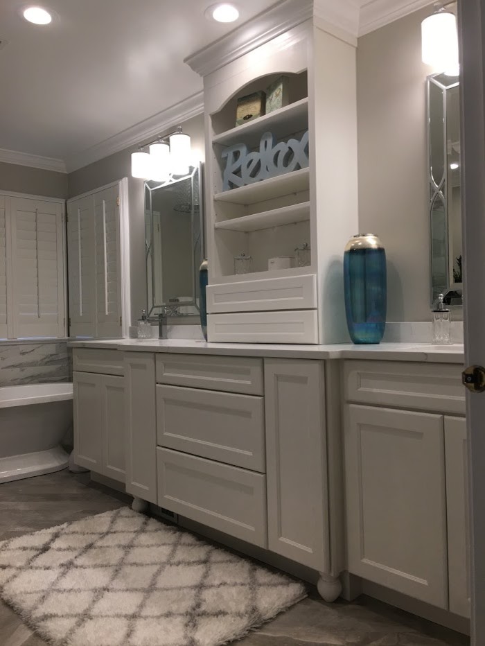 Design ideas for a medium sized traditional ensuite bathroom in DC Metro with recessed-panel cabinets, white cabinets, a freestanding bath, a corner shower, grey tiles, marble tiles, grey walls, marble flooring, a submerged sink, granite worktops, grey floors, a hinged door and white worktops.