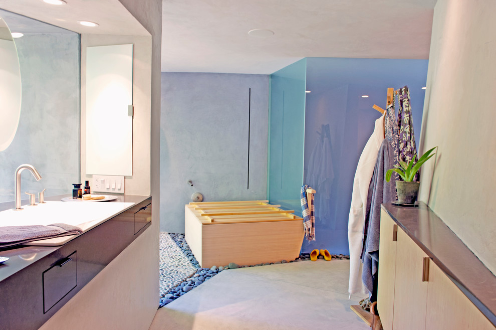 Exempel på ett mellanstort modernt en-suite badrum, med ett nedsänkt handfat, släta luckor, svarta skåp, bänkskiva i akrylsten, ett japanskt badkar, en öppen dusch, en vägghängd toalettstol, beige väggar och betonggolv