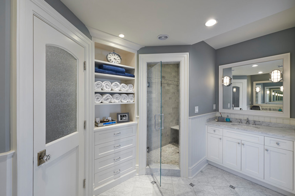 Photo of a large classic shower room bathroom in Other with recessed-panel cabinets, white cabinets, a corner shower, grey walls, marble flooring, a submerged sink, marble worktops, grey floors, a hinged door and white worktops.