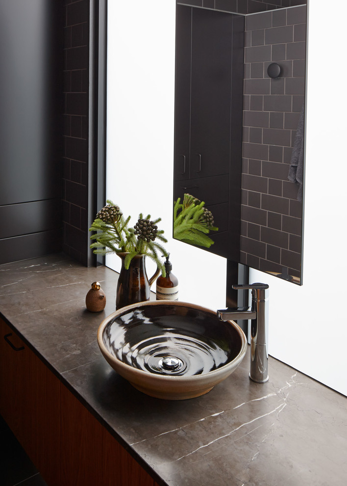Cette photo montre une salle de bain principale tendance en bois brun avec une vasque, un plan de toilette en marbre et un carrelage gris.