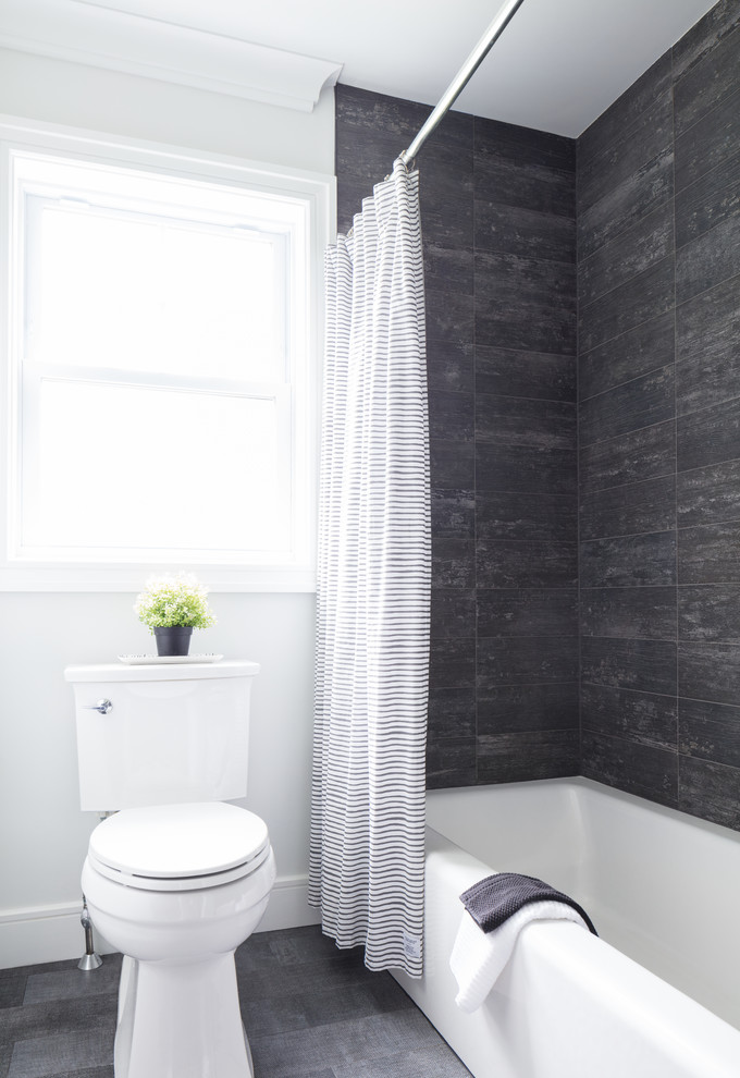 This is an example of a small country shower room bathroom in New York with a built-in bath, a shower/bath combination, a two-piece toilet, black tiles, porcelain tiles, white walls, porcelain flooring, a submerged sink, black floors and a shower curtain.