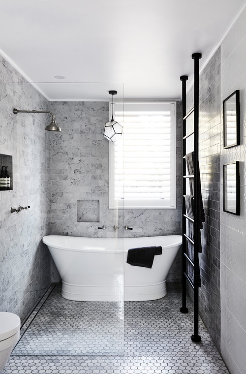 A Freestanding Bathtub Amid Classic Marble Tiles
