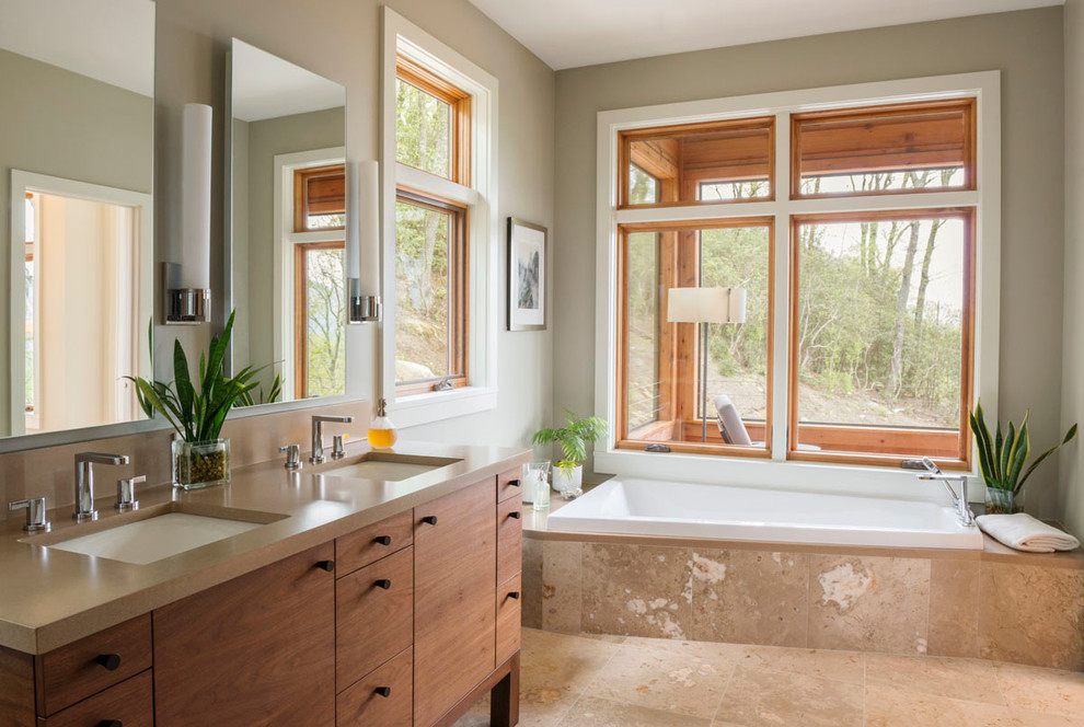 Contemporary bathroom in Other with flat-panel cabinets, light wood cabinets and a built-in bath.