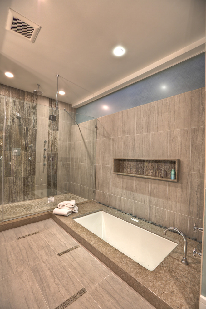 Inspiration for a large modern ensuite bathroom in Houston with flat-panel cabinets, black cabinets, a submerged bath, a walk-in shower, grey tiles, stone tiles, porcelain flooring, a submerged sink, engineered stone worktops, grey floors and an open shower.