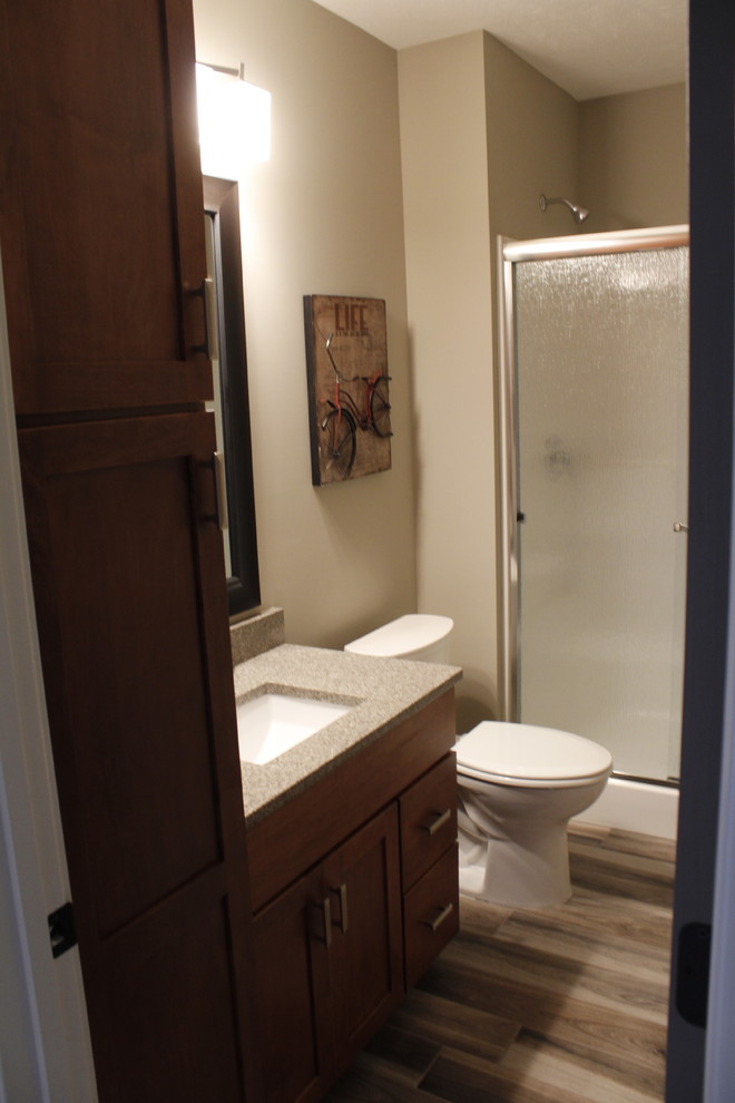 This is an example of a small classic family bathroom in Other with a submerged sink, recessed-panel cabinets, dark wood cabinets, quartz worktops, a double shower, a one-piece toilet, grey tiles, ceramic tiles, grey walls and ceramic flooring.