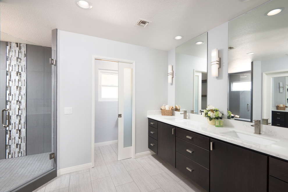 Large transitional master gray tile and ceramic tile ceramic tile alcove shower photo in San Diego with flat-panel cabinets, dark wood cabinets, a one-piece toilet, gray walls, an undermount sink, granite countertops and a hinged shower door