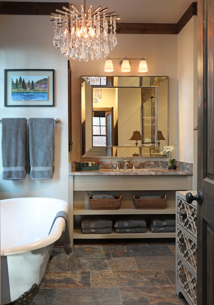This is an example of a medium sized classic ensuite bathroom in Atlanta with open cabinets, beige cabinets, a claw-foot bath, an alcove shower, a one-piece toilet, grey tiles, stone tiles, beige walls, slate flooring, a submerged sink, granite worktops and brown floors.