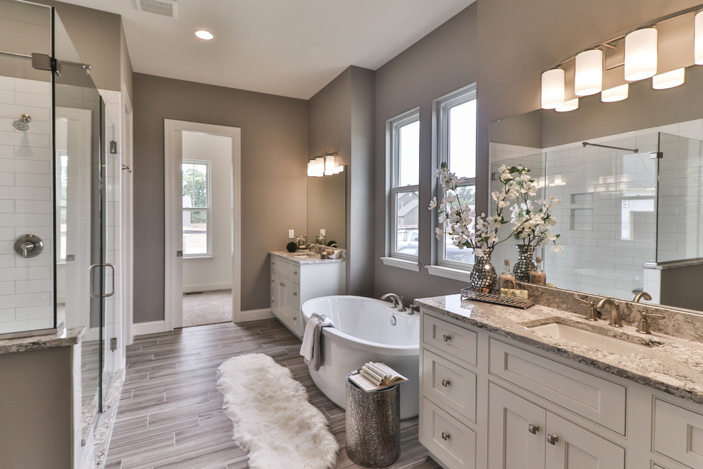 Mid-sized transitional master white tile and porcelain tile vinyl floor and gray floor bathroom photo in St Louis with shaker cabinets, dark wood cabinets, a two-piece toilet, beige walls, an undermount sink, granite countertops and a hinged shower door