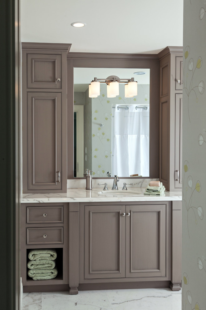 Inspiration for a beach style bathroom in Boston with a submerged sink, recessed-panel cabinets and brown cabinets.