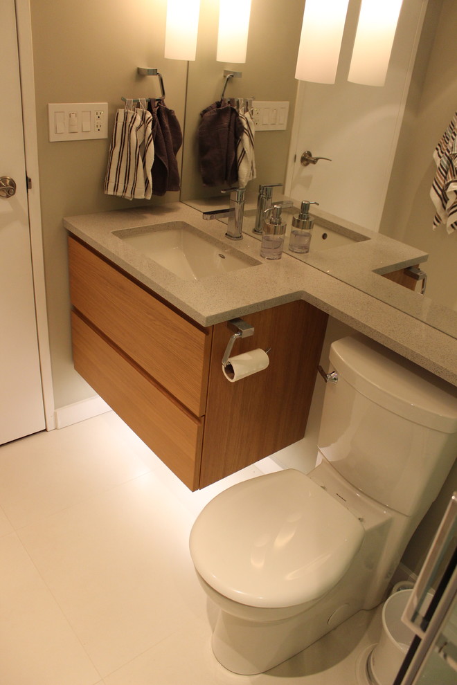 Ispirazione per una stanza da bagno minimalista con lavabo sottopiano, ante lisce, ante in legno chiaro, top in quarzo composito, WC a due pezzi, piastrelle bianche e piastrelle in gres porcellanato