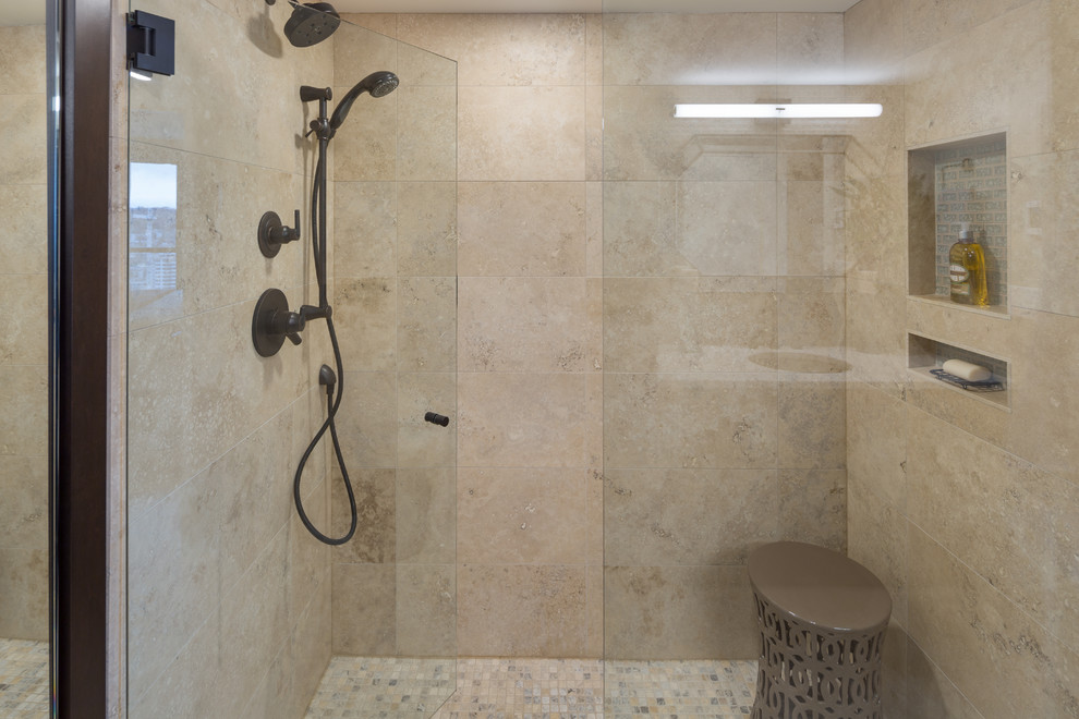 На фото: главная ванная комната среднего размера в стиле модернизм с стеклянными фасадами, унитазом-моноблоком, бежевой плиткой, бежевыми стенами, раковиной с несколькими смесителями, двойным душем и душем с распашными дверями
