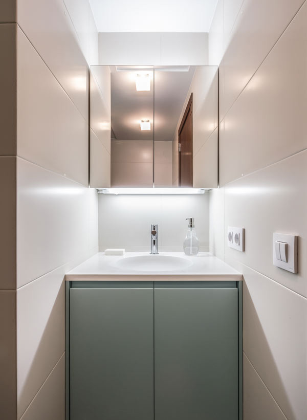 Inspiration for a small contemporary family bathroom in Auckland with blue cabinets, quartz worktops, an alcove shower, a wall mounted toilet, beige tiles, ceramic tiles, beige walls, ceramic flooring and an integrated sink.