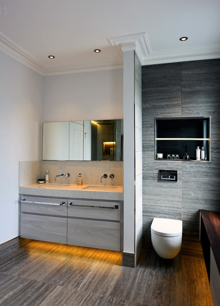 Design ideas for a medium sized contemporary family bathroom in London with flat-panel cabinets, brown cabinets, a freestanding bath, a walk-in shower, a wall mounted toilet, grey tiles, ceramic tiles, white walls, ceramic flooring, a built-in sink, quartz worktops, grey floors, an open shower and white worktops.