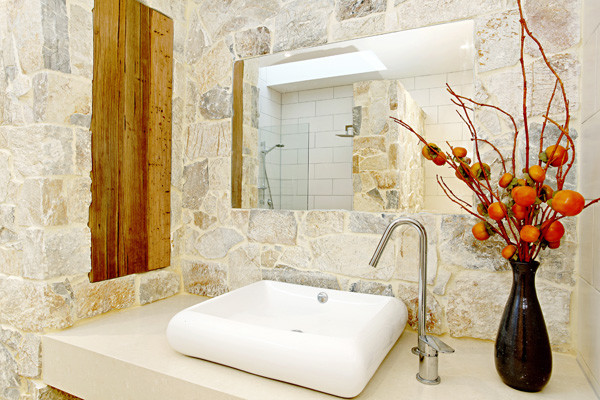 Modelo de cuarto de baño principal costero de tamaño medio con baldosas y/o azulejos de piedra y suelo de travertino