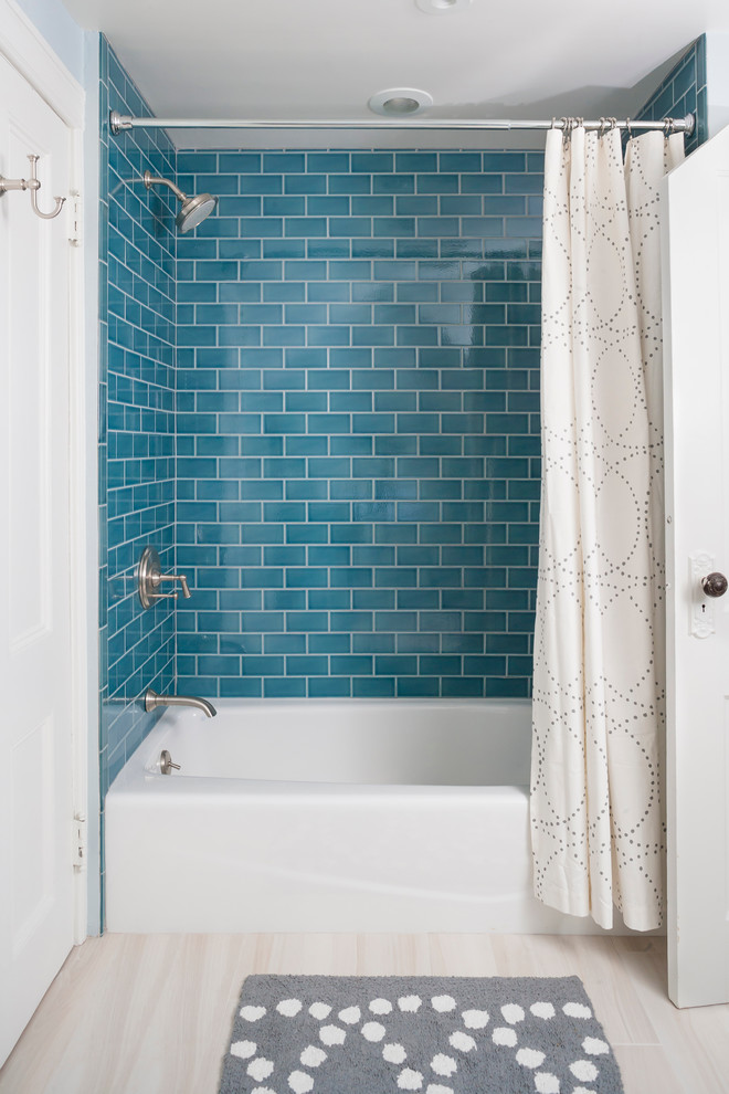 Elegant blue tile and subway tile bathroom photo in New York