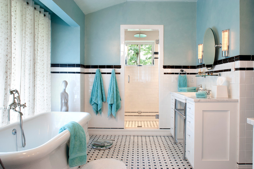 Elegant mosaic tile and black and white tile multicolored floor freestanding bathtub photo in Other with a console sink