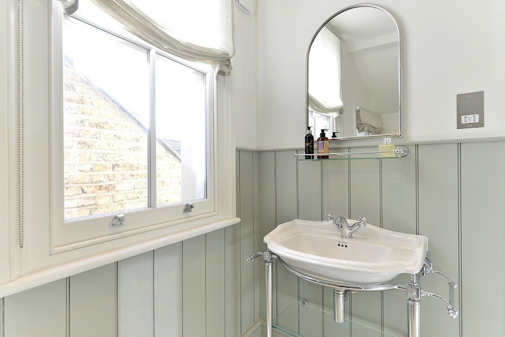 Inspiration for a medium sized victorian family bathroom in London with flat-panel cabinets, green cabinets, an alcove bath, a walk-in shower, a one-piece toilet, green tiles, white walls, medium hardwood flooring, a built-in sink, wooden worktops, white floors and an open shower.