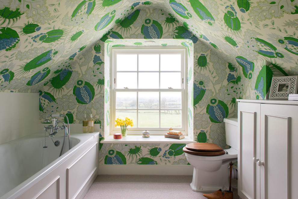 Inspiration for a farmhouse kids' beige floor alcove bathtub remodel in Gloucestershire with recessed-panel cabinets, white cabinets, a two-piece toilet and green walls