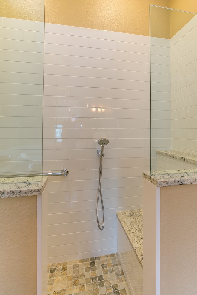 Example of a mid-sized asian master white tile and subway tile slate floor bathroom design in Tampa with flat-panel cabinets, medium tone wood cabinets, beige walls, an undermount sink and quartz countertops