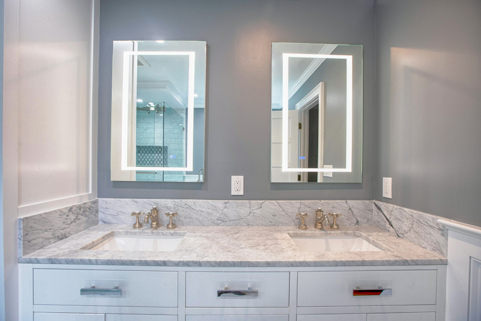 Example of a large transitional master white tile and marble tile porcelain tile, white floor, double-sink and wall paneling bathroom design in New York with shaker cabinets, white cabinets, a one-piece toilet, gray walls, an undermount sink, marble countertops, white countertops and a freestanding vanity