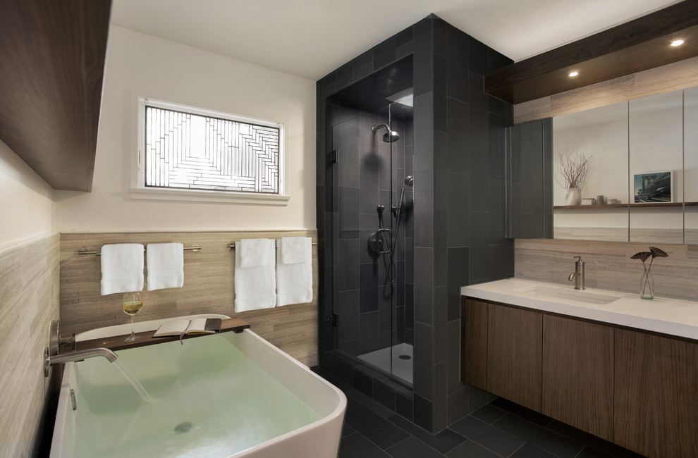 Design ideas for a contemporary half tiled bathroom in Boston with flat-panel cabinets, dark wood cabinets, a freestanding bath, an alcove shower and beige tiles.