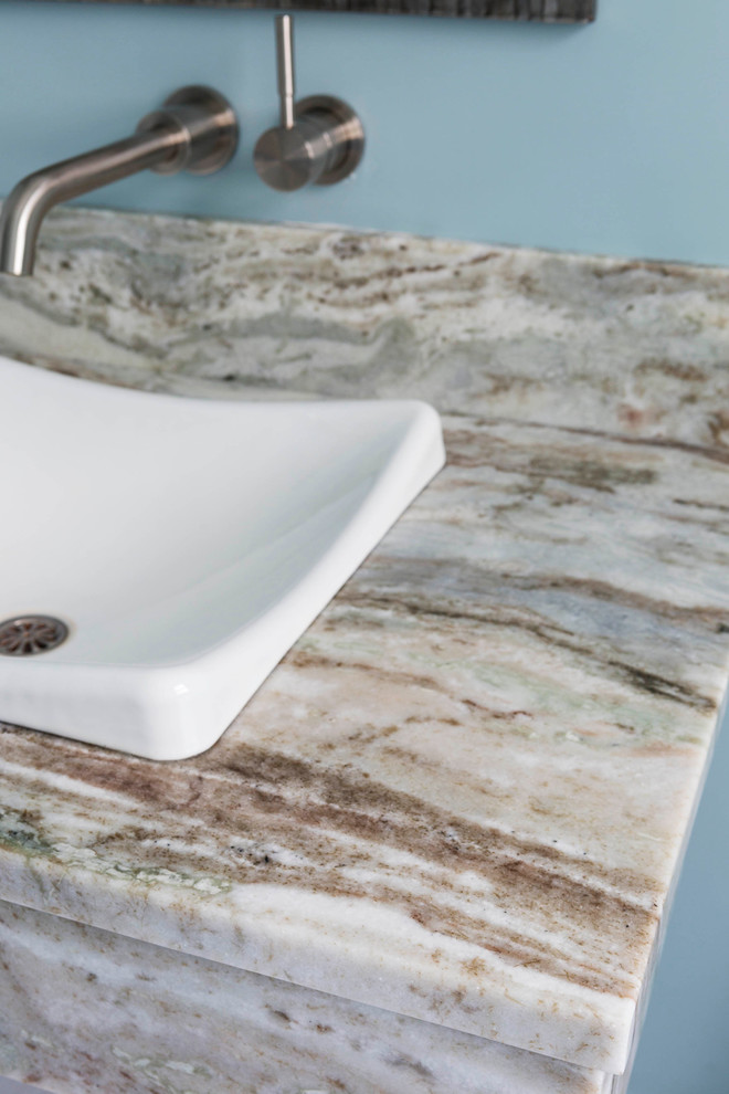 Inspiration for a small modern bathroom remodel in Boston with a wall-mount sink and quartzite countertops