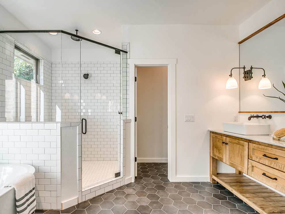 Mid-sized country master white tile and subway tile ceramic tile and black floor bathroom photo in Oklahoma City with shaker cabinets, medium tone wood cabinets, a one-piece toilet, white walls, a vessel sink, marble countertops and a hinged shower door