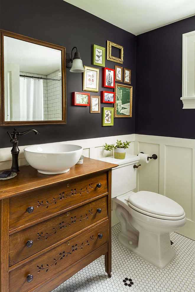 Country bathroom in DC Metro with medium wood cabinets, black walls, mosaic tile flooring, a vessel sink, white floors and flat-panel cabinets.