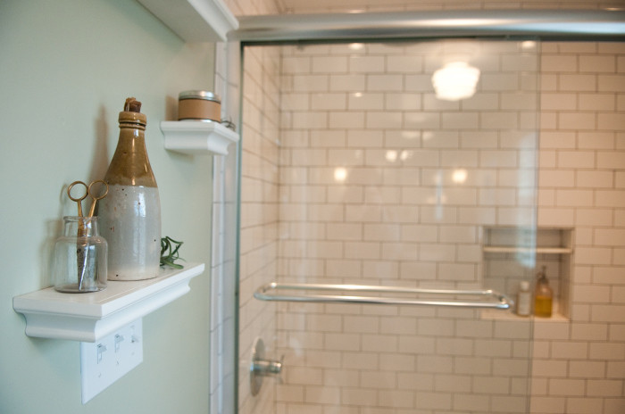 Photo of a medium sized rural ensuite bathroom in Providence with a vessel sink, an alcove bath, a shower/bath combination, a two-piece toilet, white tiles, metro tiles, grey walls and porcelain flooring.