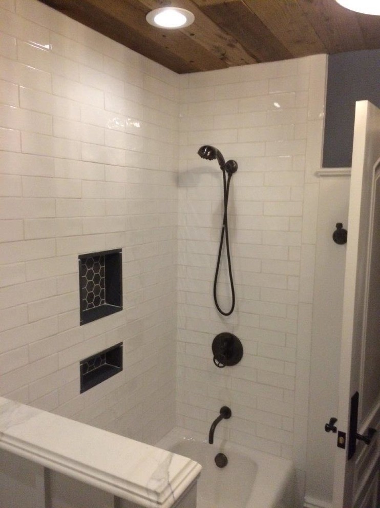 Photo of a farmhouse bathroom in New York with an alcove bath, a shower/bath combination, grey walls, mosaic tile flooring, a submerged sink, marble worktops, white tiles and metro tiles.