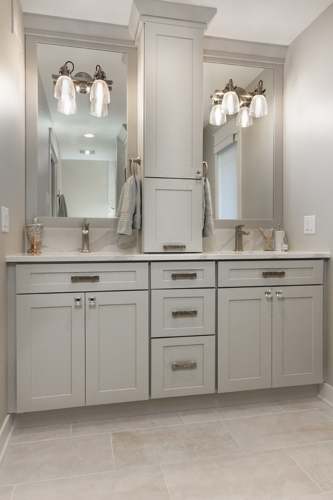 Medium sized traditional ensuite bathroom in Other with shaker cabinets, grey cabinets, an alcove bath, a shower/bath combination, a two-piece toilet, white tiles, porcelain tiles, grey walls, porcelain flooring, a submerged sink, engineered stone worktops, white floors, a sliding door and white worktops.