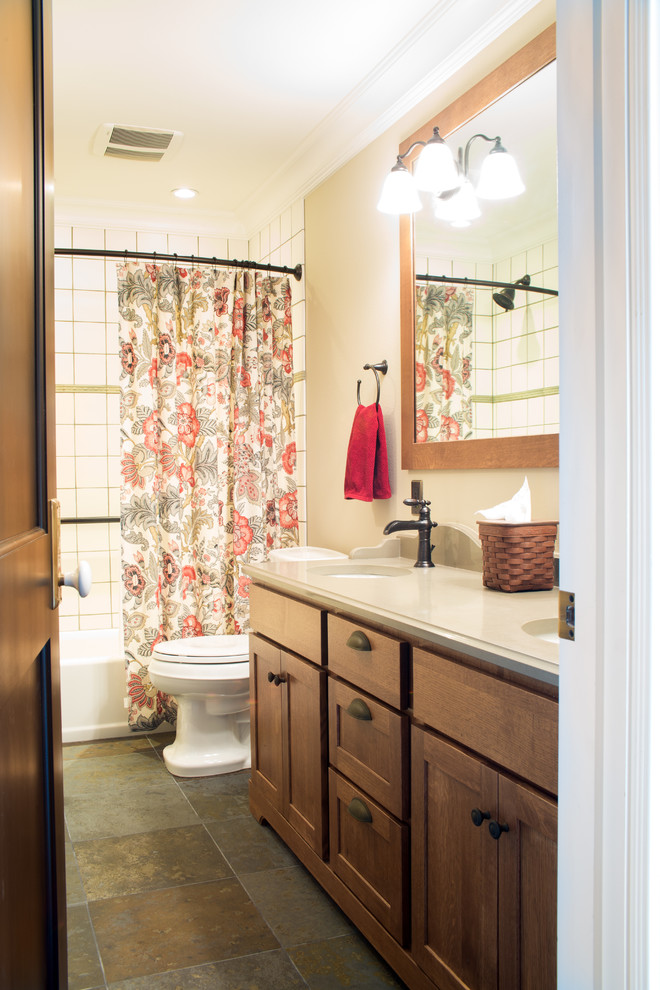 Foto på ett mellanstort lantligt badrum, med ett undermonterad handfat, skåp i shakerstil, skåp i mellenmörkt trä, bänkskiva i kvarts, ett badkar i en alkov, en dusch/badkar-kombination, flerfärgad kakel, stenkakel, beige väggar och skiffergolv