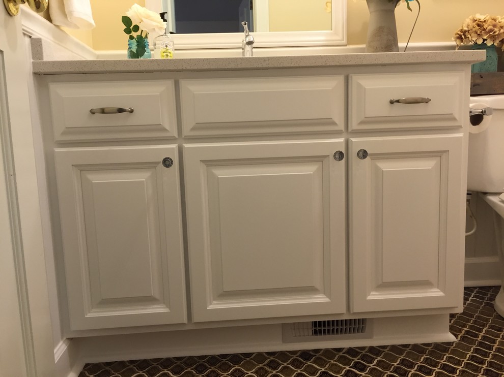Inspiration for a mid-sized cottage brown tile and ceramic tile ceramic tile tub/shower combo remodel in Charleston with an undermount sink, raised-panel cabinets, white cabinets, quartzite countertops and yellow walls