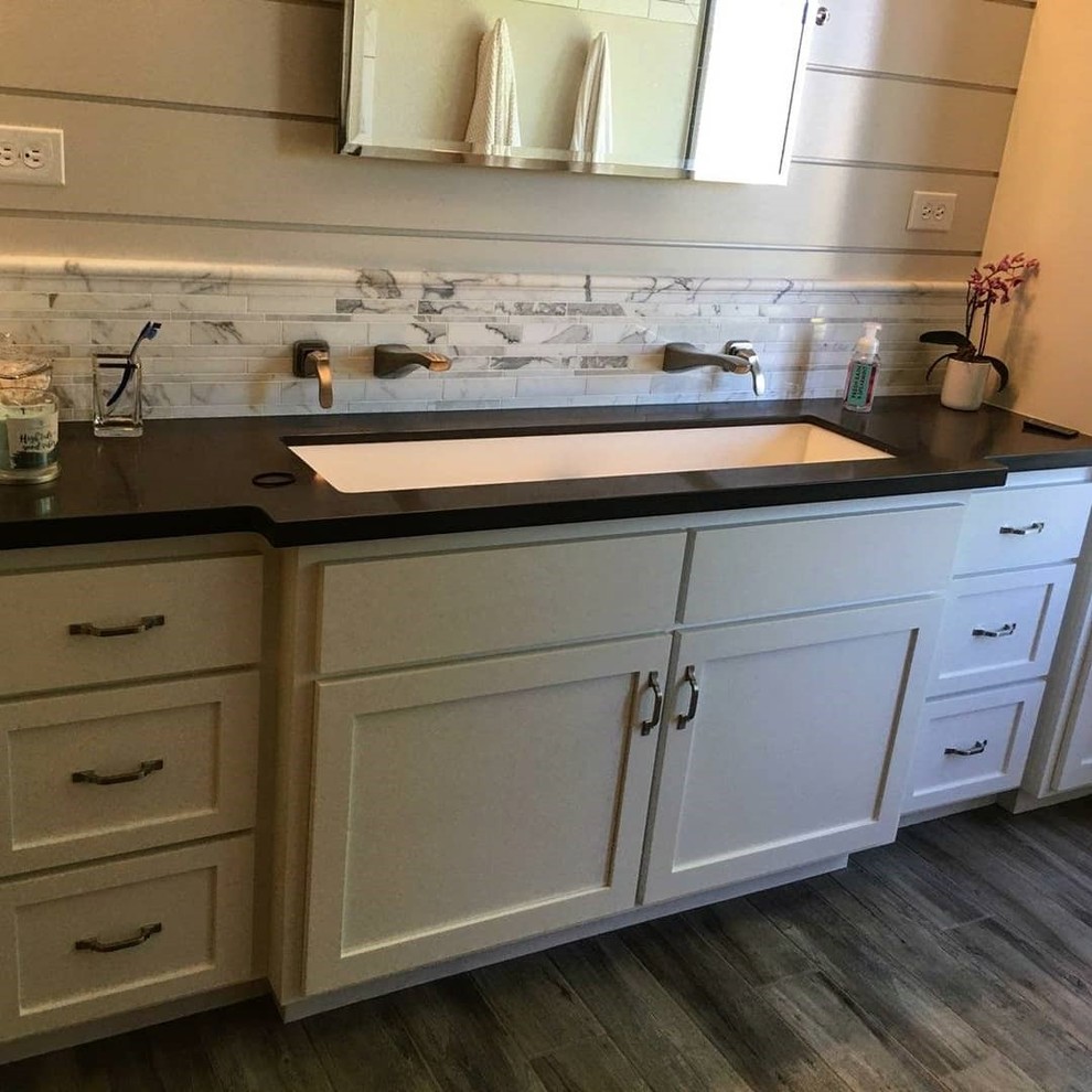 Inspiration for a large farmhouse master white tile and marble tile porcelain tile and gray floor bathroom remodel in Sacramento with shaker cabinets, white cabinets, white walls, a trough sink, quartz countertops and black countertops