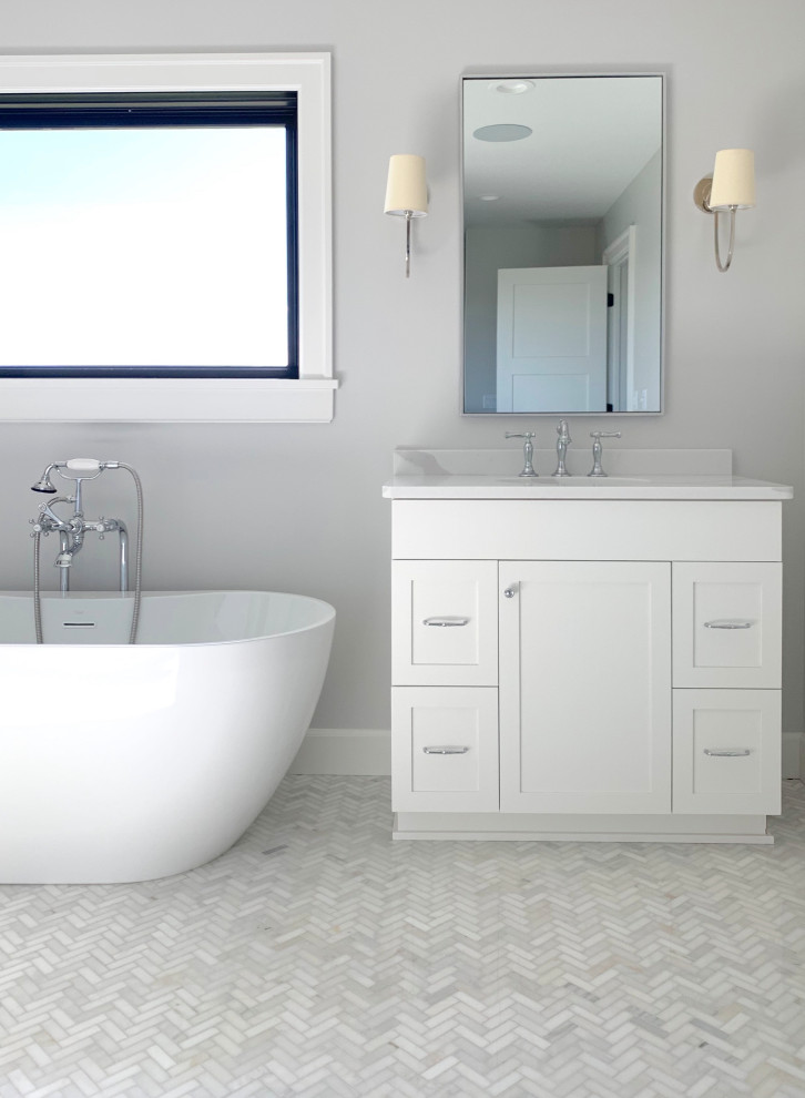 This is an example of a large farmhouse ensuite bathroom in Other with shaker cabinets, white cabinets, a freestanding bath, white tiles, metro tiles, grey walls, a submerged sink, engineered stone worktops, white floors, an open shower and grey worktops.