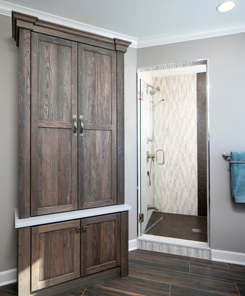 Inspiration for a large country ensuite bathroom in Minneapolis with recessed-panel cabinets, medium wood cabinets, an alcove shower, grey walls, wood-effect flooring, a submerged sink, brown floors, a hinged door, white worktops and granite worktops.
