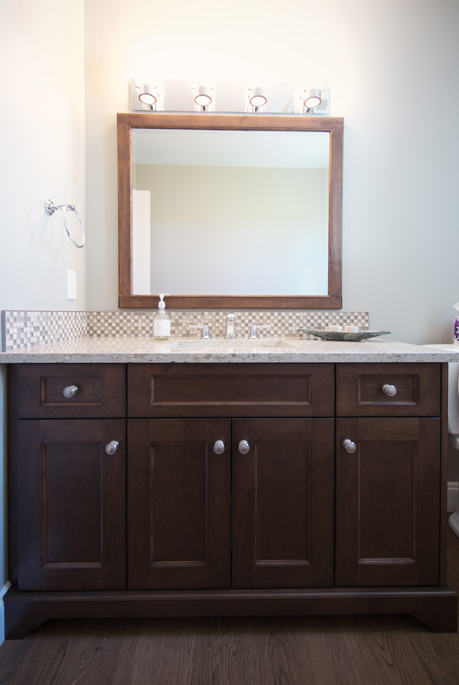 Bathroom - large traditional 3/4 multicolored tile and mosaic tile medium tone wood floor bathroom idea in Vancouver with an undermount sink, recessed-panel cabinets, medium tone wood cabinets and solid surface countertops