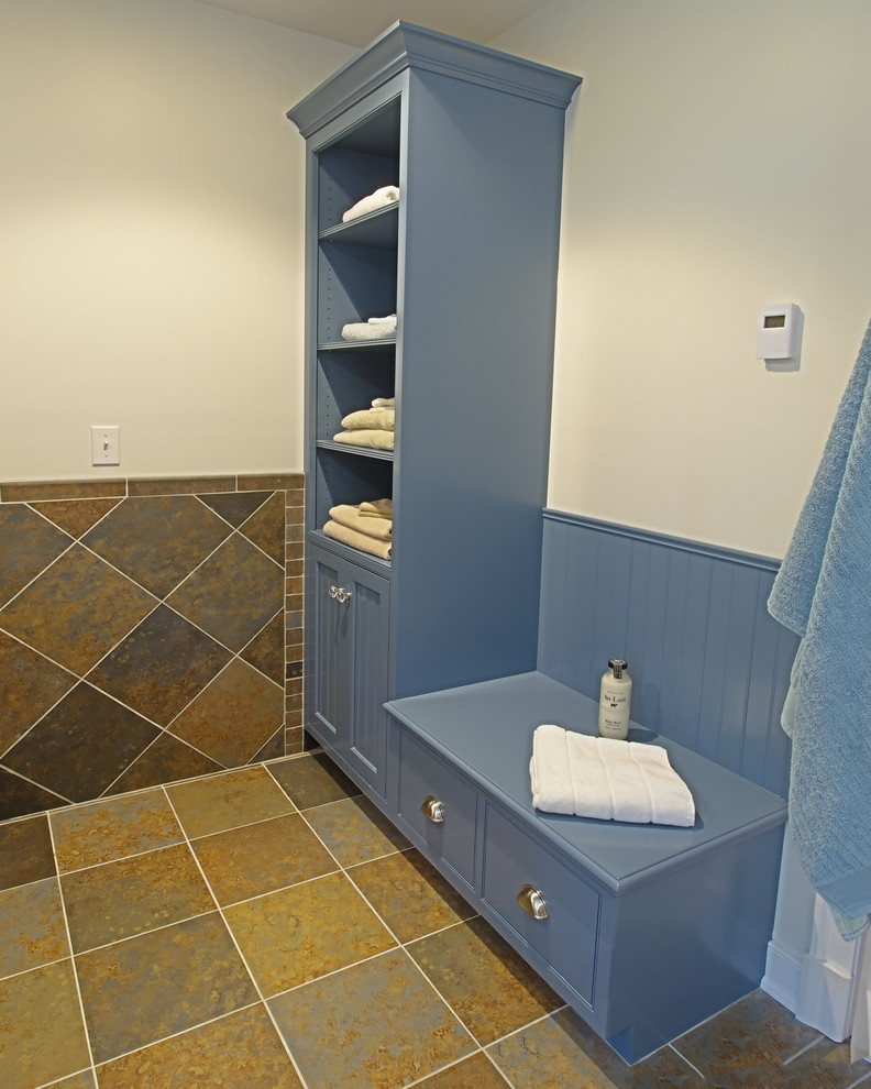 Medium sized traditional bathroom in Philadelphia with shaker cabinets, blue cabinets, a built-in bath, white walls, slate flooring, a submerged sink and solid surface worktops.