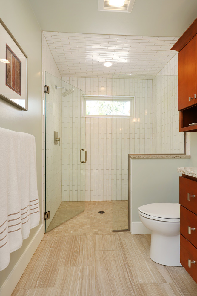 Design ideas for a small classic ensuite bathroom in Grand Rapids with flat-panel cabinets, medium wood cabinets, a built-in shower, white walls, ceramic flooring, a submerged sink, granite worktops, beige floors and a hinged door.