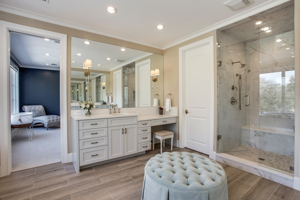 Mediterranean bathroom in Dallas with shaker cabinets, white cabinets, an alcove shower, beige walls, a submerged sink, brown floors, a hinged door and white worktops.