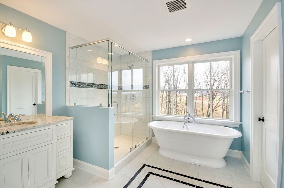 Example of a classic master gray tile, white tile and stone tile marble floor bathroom design in Other with recessed-panel cabinets, white cabinets, blue walls, an undermount sink and granite countertops
