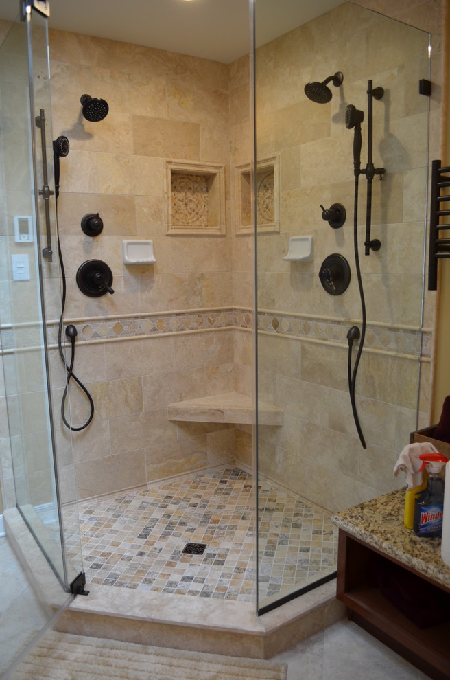 Photo of a large classic ensuite bathroom in Baltimore with raised-panel cabinets, medium wood cabinets, a submerged bath, a corner shower, a two-piece toilet, beige tiles, ceramic tiles, beige walls, ceramic flooring, a submerged sink, granite worktops, beige floors and a hinged door.