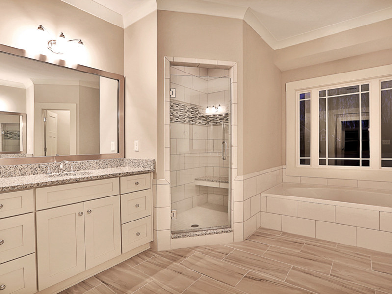 Design ideas for a medium sized contemporary ensuite bathroom in Atlanta with shaker cabinets, white cabinets, a built-in bath, an alcove shower, a two-piece toilet, grey tiles, ceramic tiles, grey walls, ceramic flooring, a submerged sink and granite worktops.