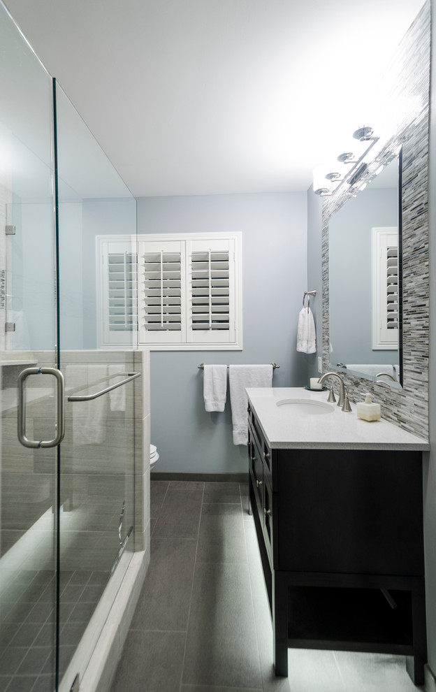 Double shower - small transitional green tile porcelain tile double shower idea in Other with an undermount sink, shaker cabinets, dark wood cabinets, quartz countertops, a two-piece toilet and blue walls